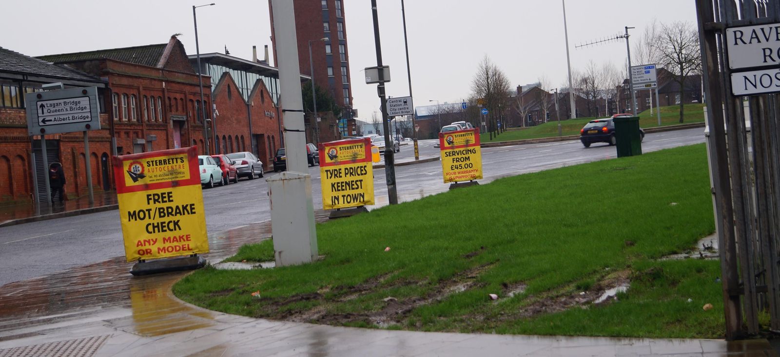 Sterrett's roadside signs on Ravenhill Road advertising MOT and brake checks